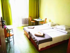 a hotel room with a bed and a table and chairs at Zajazd Irys in Sosnowiec