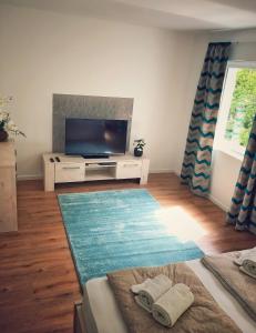 A television and/or entertainment centre at Moment Apartments