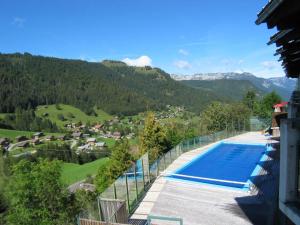 a swimming pool with a view of a mountain at Aravis 1500-11 - 2 pieces et coin nuit in La Clusaz