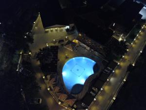 an overhead view of a swimming pool at night at Riviera Perdika Hotel in Perdika