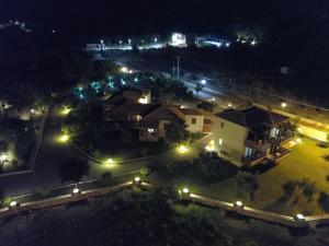 an aerial view of a house at night with lights at Riviera Perdika Hotel in Perdika
