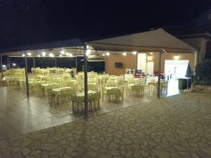 a group of tables and chairs under a tent at Riviera Perdika Hotel in Perdika