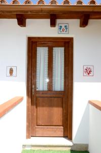a wooden door on the side of a house at B&B Il Mirto di Paola in Torpè