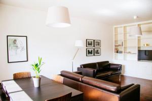 a living room with a couch and a table at Typical Apartment in Lisbon, Campo Grande (Parking included) in Lisbon