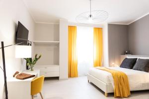 a bedroom with a bed and a desk and a tv at Li Cetti in Lecce
