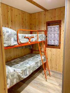 a room with two bunk beds in a cabin at Villaggio Turistico Camping Cervino in Antey-Saint-André