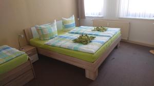 sypialnia z 2 łóżkami w kolorze zielonym i niebieskim w obiekcie Ferienwohnung am Markt w mieście Quedlinburg