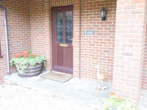 una casa de ladrillo con una puerta y una maceta en At Last Bed & Breakfast en Edlington