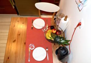 a table with a bowl of fruit on top of it at Acropolis in Athens