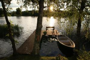 a boat parked next to a dock on a lake at Purjemaja in Otepää