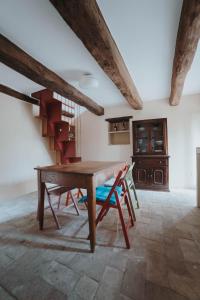 a dining room with a wooden table and chairs at Ostello Bello Assisi Bevagna in Bevagna