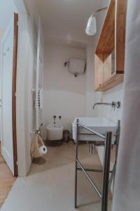 a small bathroom with a sink and a toilet at Ostello Bello Assisi Bevagna in Bevagna