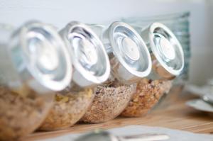 a row of jars filled with oats on a counter at also-Hotel an der Hardt in Wuppertal