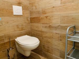 a bathroom with a toilet and a wooden wall at Victoire Appartement in Aix-en-Provence +19 photos