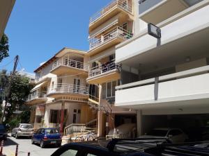 a tall building with cars parked in front of it at Ground Floor Studio Galini in Rethymno