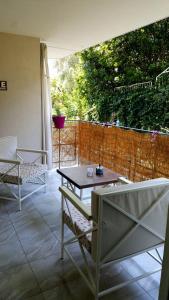 a patio with a table and chairs and a fence at Rooms Villa Harmonie - Adults Only +14 in Crikvenica