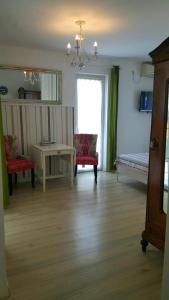 a living room with a bed and a table and chairs at Rooms Villa Harmonie - Adults Only +14 in Crikvenica