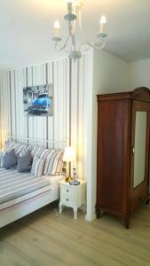 a bedroom with a bed and a table with a lamp at Rooms Villa Harmonie - Adults Only +14 in Crikvenica