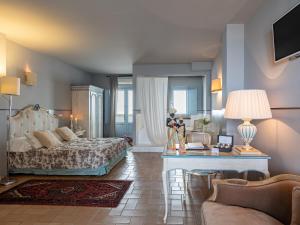 a bedroom with a bed and a living room at La Locanda Del Carrubo in Mattinata