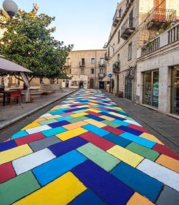 a street with a colorful floor in the middle of a street at B&B Piazza di L'Ara in Tempio Pausania