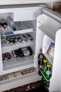 an open refrigerator filled with lots of drinks at Бутик-Отель "Zeytun" in Izmail