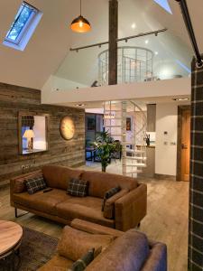 a living room with a couch and a table at Balloan Cottage in Inverness