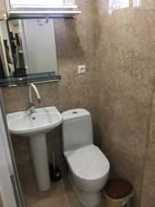 ein Badezimmer mit einem weißen WC und einem Waschbecken in der Unterkunft 10 shindisi street,Tbilisi in Tbilisi City