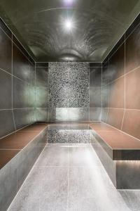 an empty room with a tile floor and a ceiling at Hotel Madeleine in Obergurgl