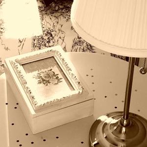 a white box with a picture in it next to a lamp at Apartments Villa Harmonie - Adults Only +14 in Crikvenica
