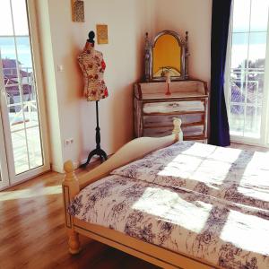 a bedroom with a bed and a dresser and a mirror at Apartments Villa Harmonie - Adults Only +14 in Crikvenica