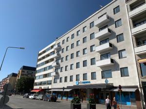 a building on a street with people walking in front of it at Heaven in Pori