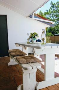 a white table with cushioned chairs on a patio at 9 on Drommedaris in Stellenbosch