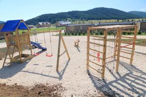 a group of playground equipment in the sand at Big Bear Plitvice Nature Resort in Donji Babin Potok