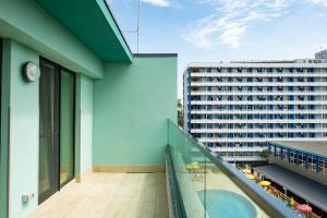 a balcony with a view of a building at ZIP Apartments in Mamaia