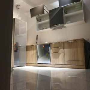 a kitchen with wooden cabinets and a sink at LUKA in Budva