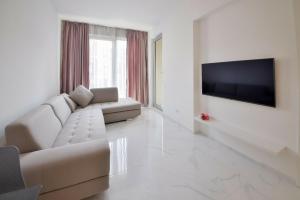 a living room with a couch and a flat screen tv at LUKA in Budva