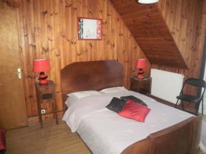 a bedroom with a large bed with two lamps on tables at grand gite in Cier-de-Luchon