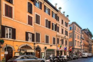 a street with cars parked in front of buildings at Romefinestay Apartments Sistina in Rome