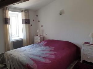 a bedroom with a large bed and a window at Ma Maison in Le Château-dʼOléron