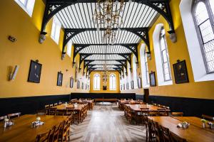 a large room with tables and chairs and a chandelier at Maynooth Campus Accommodation in Maynooth