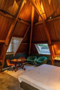 a bedroom with a bed and two chairs and a table at Slot Oostende in Goes