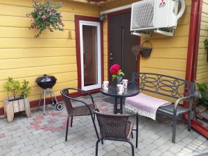 a patio with a table and chairs and a fan at Theodori Holiday House in Pärnu
