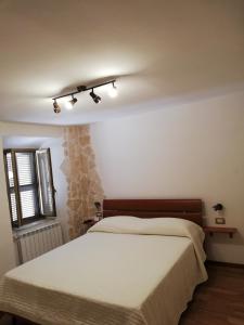 a bedroom with a bed and a window at Historical Domus in Anagni