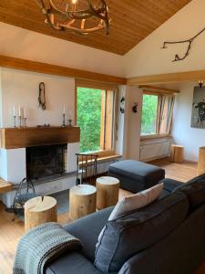 a living room with a couch and a fireplace at Mira Selva in Trin