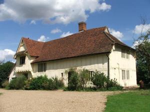 a large white house with a brown roof at FSC Flatford Mill Hostel in East Bergholt