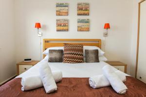 a bedroom with a large white bed with two pillows at Britannia Harbour View - Parking - by Brighton Holiday Lets in Brighton & Hove