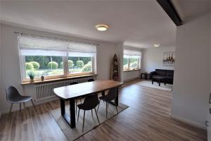 a dining room and living room with a table and chairs at FEWO-Alexandra in Hohwacht