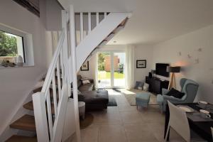 a living room with a staircase leading to a living room at Nordlicht-Reiher-2-Appat-3 in Hohwacht