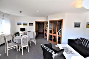 a living room with a couch and a table at Sanddorn-Ostseering-4C in Hohwacht