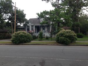a white house with bushes in front of a street at Oakview Bed and Breakfast in New Orleans